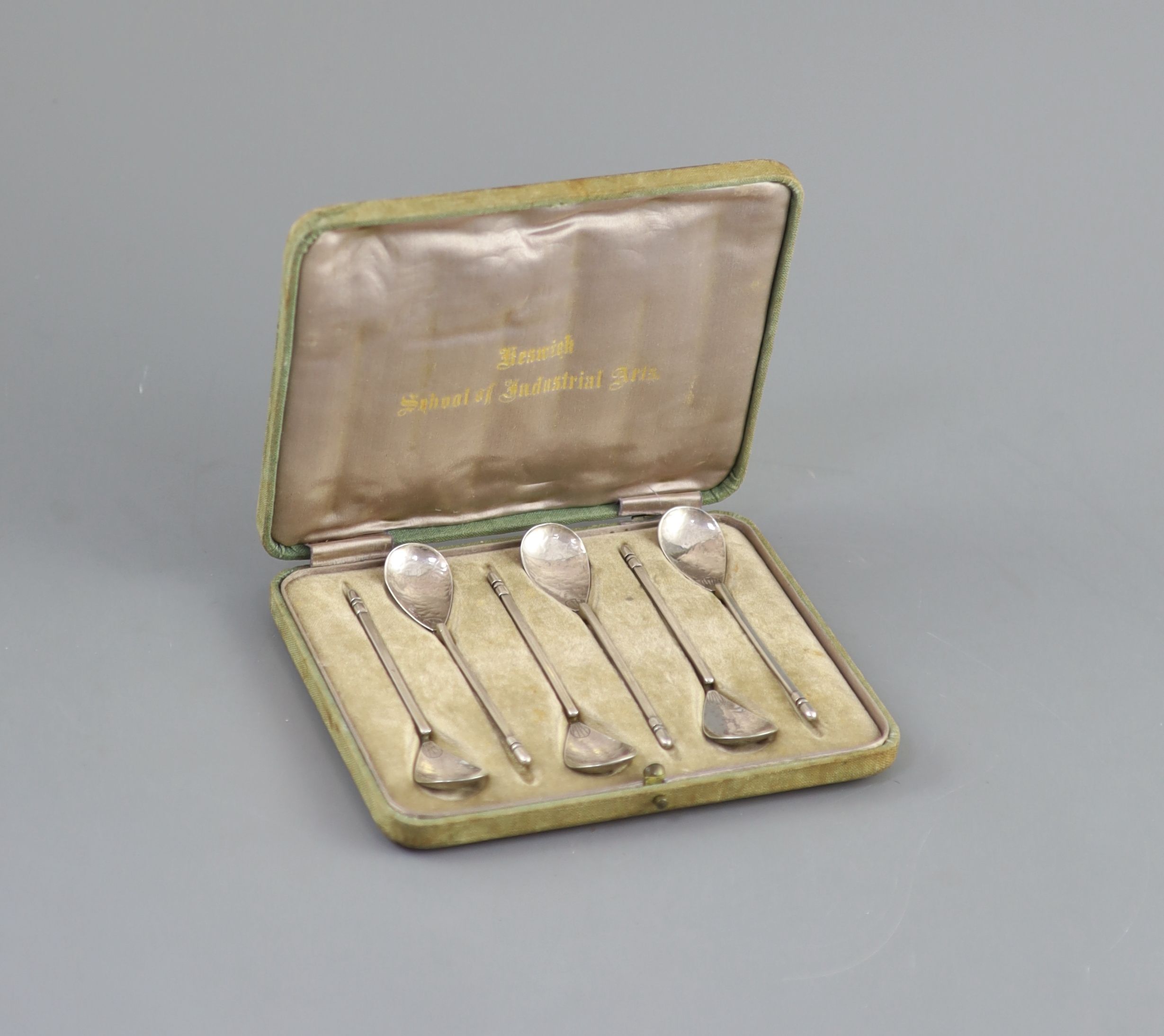 A cased set of six George V Arts & Crafts silver teaspoons, by the Keswick School of Industrial Arts